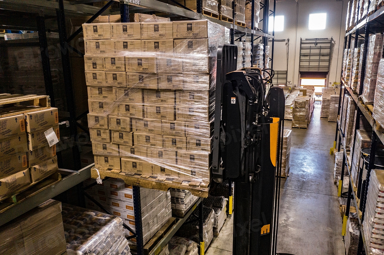 Rows of cardboard shipping boxes in a warehouse
